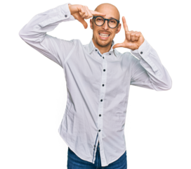 Bald man with beard wearing business shirt and glasses smiling making frame with hands and fingers with happy face. creativity and photography concept.