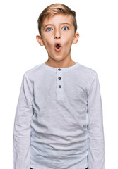 Little caucasian boy kid wearing casual clothes afraid and shocked with surprise expression, fear and excited face.