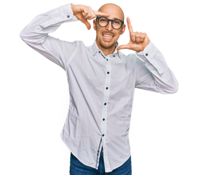 Bald man with beard wearing business shirt and glasses smiling making frame with hands and fingers with happy face. creativity and photography concept.