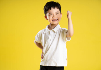 image of asian boy posing on a yellow background.