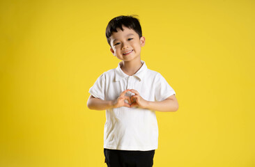 image of asian boy posing on a yellow background.
