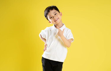 image of asian boy posing on a yellow background.