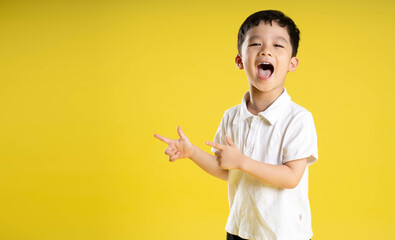 image of asian boy posing on a yellow background.