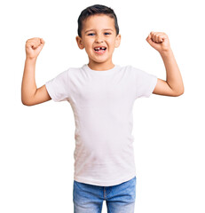 Little cute boy kid wearing casual white tshirt screaming proud, celebrating victory and success...
