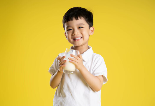 image of asian boy posing on a yellow background.