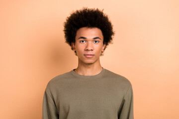 Fototapeta na wymiar Photo of handsome nice optimistic young positive guy with afro hairstyle dressed khaki shirt staring isolated on beige color background