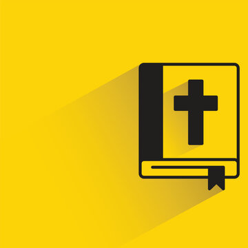 bible book with shadow on yellow background
