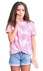 Obraz premium Cute hispanic child girl wearing casual clothes touching mouth with hand with painful expression because of toothache or dental illness on teeth. dentist