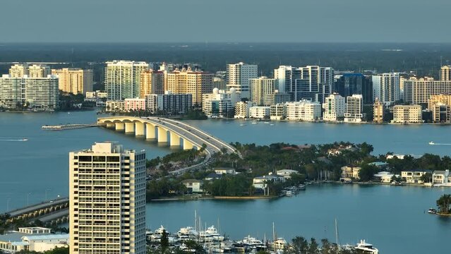 Above view of Sarasota city, Florida with waterfront office highrise buildings and John Ringling Causeway leading from downtown to St. Armands Key through Bird Key
