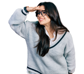 Beautiful hispanic woman wearing casual sweater and glasses very happy and smiling looking far away with hand over head. searching concept.