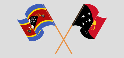 Crossed and waving flags of Eswatini and Papua New Guinea