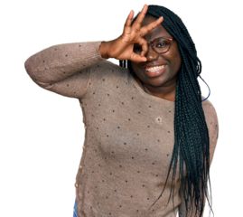 Young black woman with braids wearing casual clothes and glasses smiling happy doing ok sign with hand on eye looking through fingers