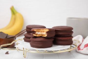 Tasty banana choco pies on white table, closeup