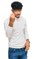 Young arab man wearing casual winter sweater doing italian gesture with hand and fingers confident expression