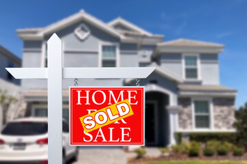 Sold Home For Sale Real Estate Sign in Front of Beautiful New House.