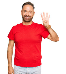 Naklejka premium Handsome middle age man wearing casual red tshirt showing and pointing up with fingers number four while smiling confident and happy.