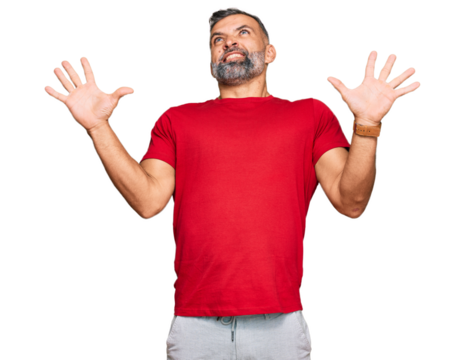 Middle age handsome man wearing casual clothes crazy and mad shouting and yelling with aggressive expression and arms raised. frustration concept.