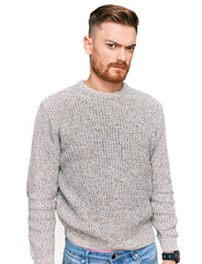 Young redhead man wearing casual winter sweater skeptic and nervous, frowning upset because of problem. negative person.