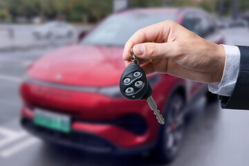 Close-up of dealer handing keys to new owners at a car show Automotive business Car sales Agreement Concept Men car salesman handing over new car keys.