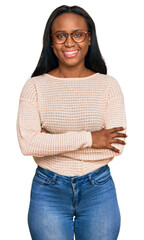 Obraz premium Young black woman wearing casual clothes and glasses happy face smiling with crossed arms looking at the camera. positive person.