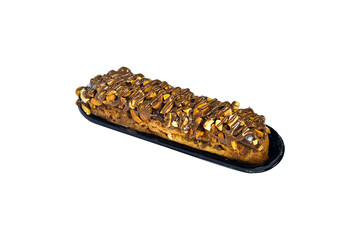 Traditional french dessert. Isolated eclair with custard and chocolate icing and peanuts on white...