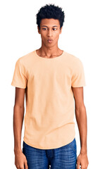 Fototapeta premium Young african american man wearing casual clothes making fish face with lips, crazy and comical gesture. funny expression.