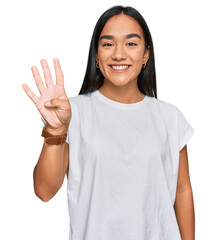 Young asian woman wearing casual white t shirt showing and pointing up with fingers number four while smiling confident and happy.