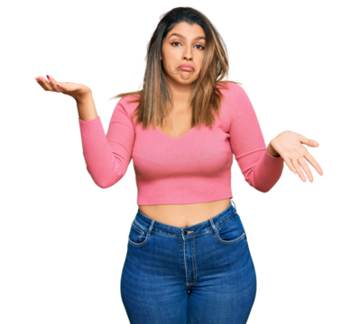 Beautiful brunette woman wearing casual clothes clueless and confused expression with arms and hands raised. doubt concept.