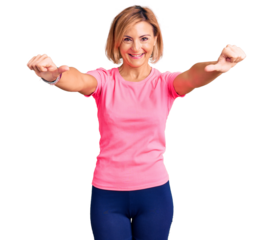 Young blonde woman wearing sportswear approving doing positive gesture with hand, thumbs up smiling and happy for success. winner gesture.