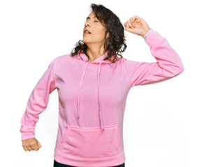 Young hispanic woman wearing casual sweatshirt stretching back, tired and relaxed, sleepy and yawning for early morning