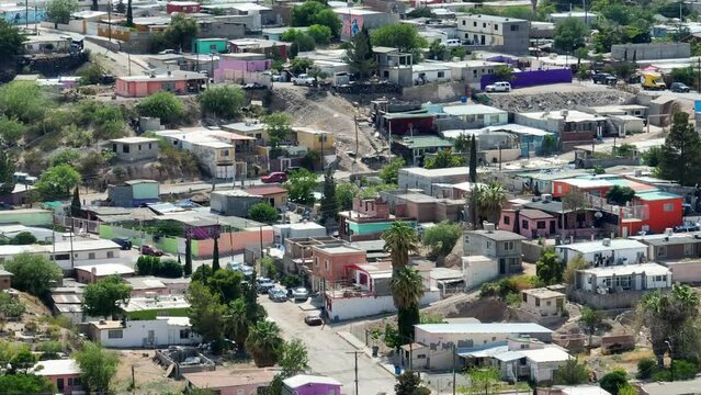 Houses and homes outside of Ciudad Juarez in Chihuahua, Mexico. Colorful housing in Mexican urban area near United States border. Aerial establishing shot with long lens.