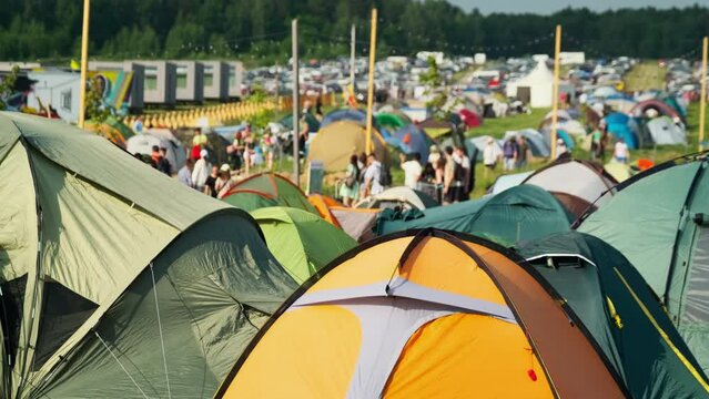 Camping area with lots of tents in countryside