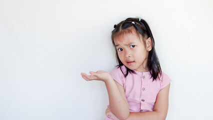 Obraz na płótnie Canvas asian child isolated doubting and shrugging shoulders in questioning gesture.
