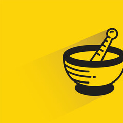 mortar and pestle with shadow on yellow background