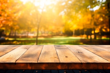 Naklejka na ściany i meble Wooden table with orange fall leaves. Autumn background with copy space. Selective focus and bokeh effect.