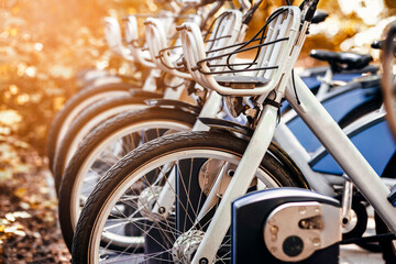 Bike Sharing or Rent. Electric Bicycles Charging Battery in Urban Parking lot in Autumn. Bike...