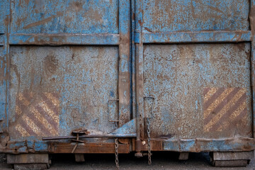 Rusty doors of an old dumpster