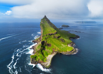 Tindholmur on Faroe Islands Vagar, aerial drone view during day in North Atlantic Ocean. Faroe...