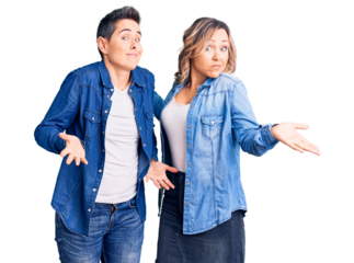 Couple of women wearing casual clothes clueless and confused expression with arms and hands raised. doubt concept.