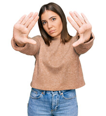 Young beautiful woman wearing casual clothes doing frame using hands palms and fingers, camera perspective