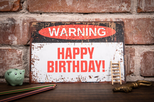 Happy Birthday. Warning sign with text on wooden texture office desk