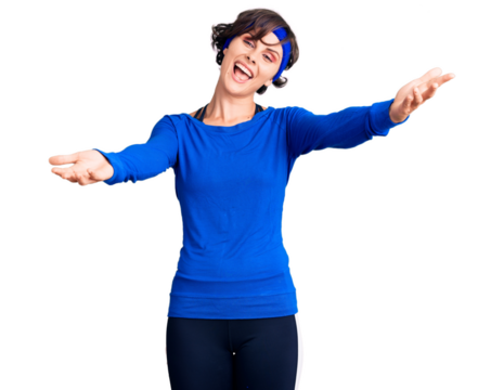 Beautiful young woman with short hair wearing training workout clothes smiling cheerful offering hands giving assistance and acceptance.