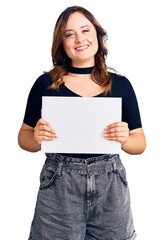 Fototapeta premium Young beautiful caucasian woman holding blank empty paper looking positive and happy standing and smiling with a confident smile showing teeth