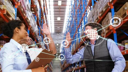 Animation of network of digital icons over team of diverse supervisors high fiving at warehouse - Powered by Adobe