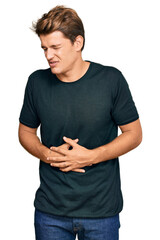 Handsome caucasian man wearing casual clothes with hand on stomach because nausea, painful disease feeling unwell. ache concept.