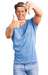 Fototapeta premium Young handsome man wearing casual clothes smiling making frame with hands and fingers with happy face. creativity and photography concept.