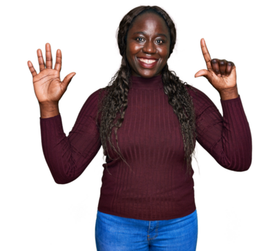 Young african woman wearing casual winter sweater showing and pointing up with fingers number seven while smiling confident and happy.