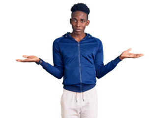 Young african american man wearing sportswear clueless and confused with open arms, no idea concept.