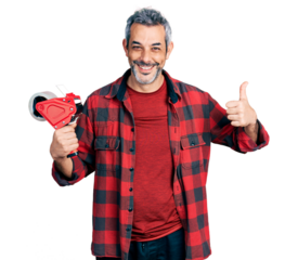 Middle age hispanic with grey hair holding packing tape smiling happy and positive, thumb up doing excellent and approval sign