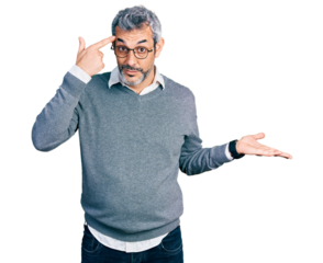 Middle age hispanic with grey hair wearing glasses confused and annoyed with open palm showing copy space and pointing finger to forehead. think about it.